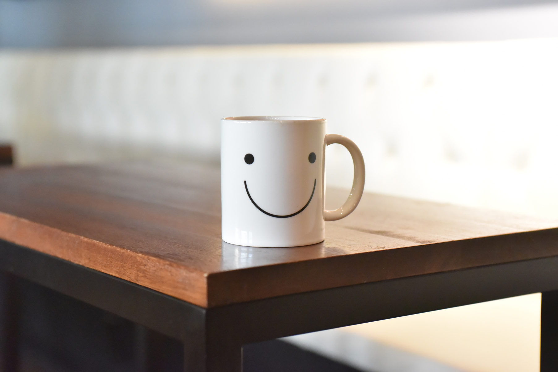 Mug With Smiling Face on Wooden Table
